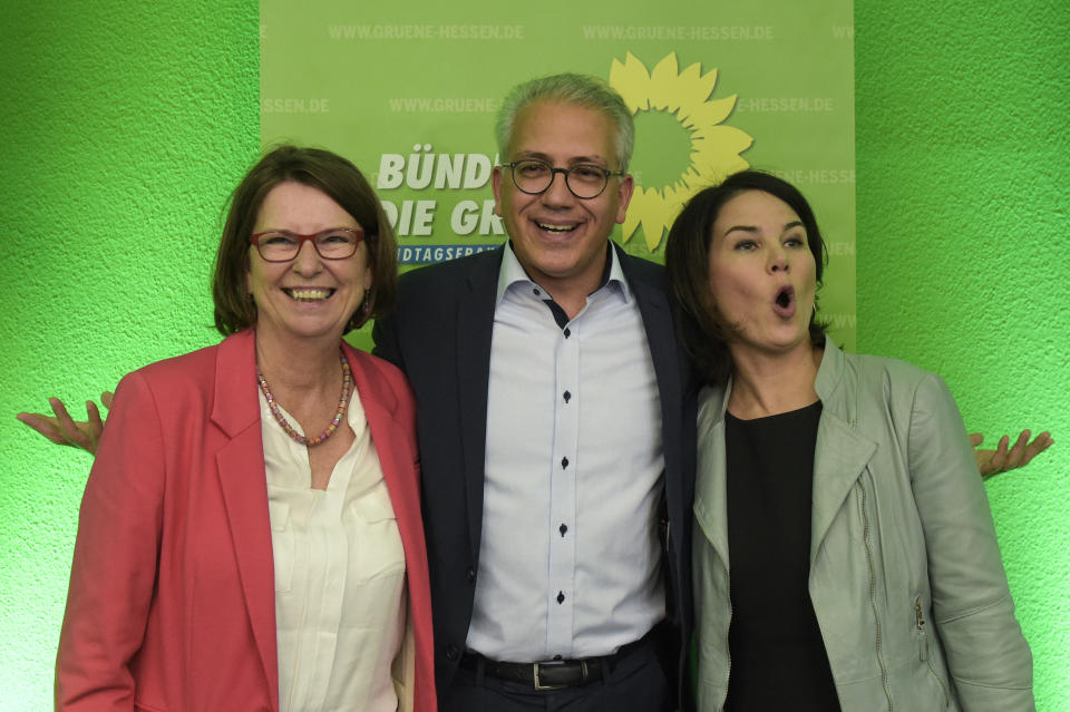 Green Party top candidates Tarek Al-Wazir, center, and Priska Hinz, left, and party co-chairwoman Annalena Baerbock, right, celebrate at a party's election party, after first results of the Hesse state election announced in Wiesbaden, Sunday, Oct. 28, 2018. (AP Photo/Jens Meyer)