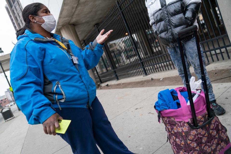 Stephanie Taylor, 50, outreach manager at Covenant House Michigan, stops at a bus stop outside of the Rosa Parks Transit Center Detroit on Dec. 9, 2022, to identify any youths who might be in need of their services.