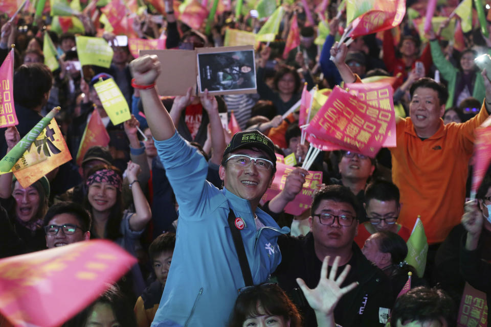 Supporters of Taiwan's 2020 presidential election candidate, Taiwan president Tsai Ing-wen cheer for Tsai's victory in Taipei, Taiwan, Saturday, Jan. 11, 2020. (AP Photo/Chiang Ying-ying)