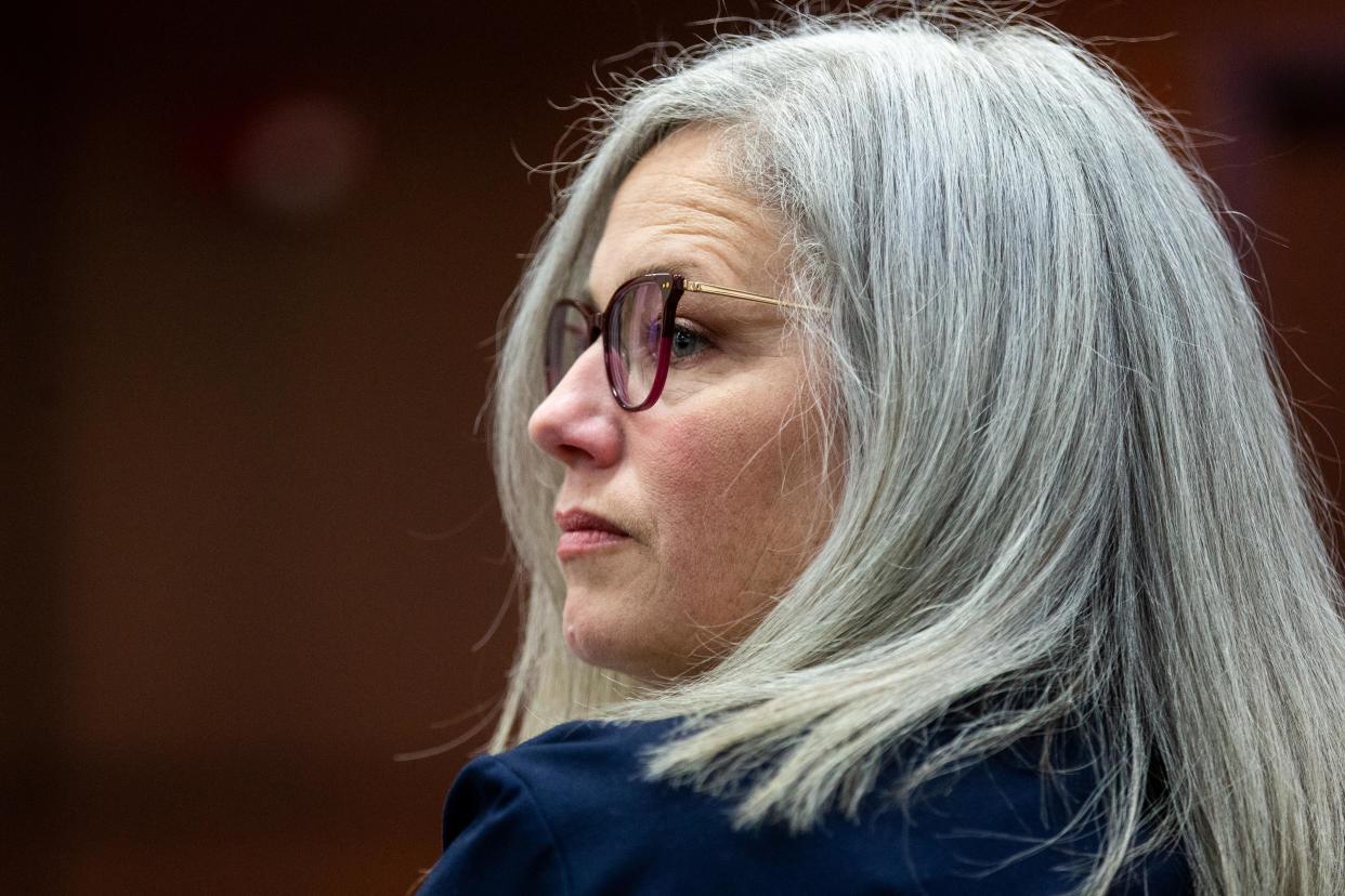 Ottawa County Health Officer Adeline Hambley looks over her shoulder as she takes her seat in the courtroom Friday, March 31, 2023, at the Michigan 14th Circuit Court in Muskegon.