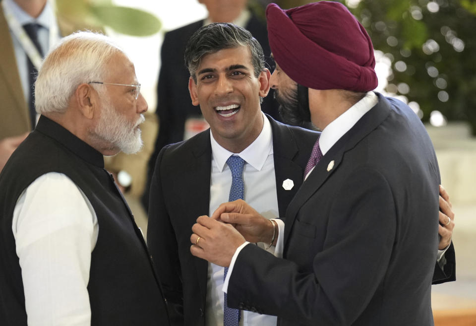 From left, India's prime minister Narendra Modi, British Prime Minister Rishi Sunak, and President of World Bank, Ajay Banga share a light moment on day two of the 50th G7 summit at Borgo Egnazia, southern Italy, on Friday, June 14, 2024. (Christopher Furlong/Pool Photo via AP)