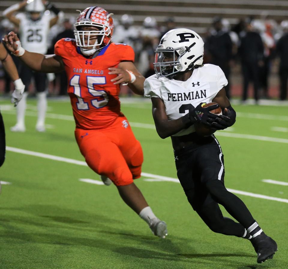 San Angelo Central High School middle linebacker Darius Floyd, left, chases after Odessa Permian's Tabarie Jones at San Angelo Stadium on Friday, Oct. 28, 2022.
