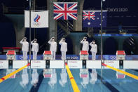 The flag raising ceremony for the men's 4x200-meters swimming relay is performed at the 2020 Summer Olympics, Wednesday, July 28, 2021, in Tokyo, Japan. (AP Photo/Matthias Schrader)