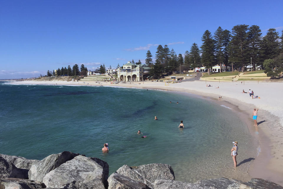 Beachgoers enjoy the Indian Ocean at Cottesloe Beach in Perth. 