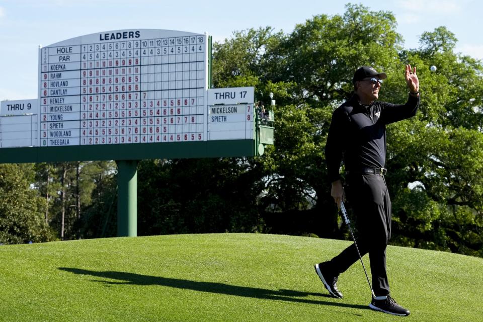 Phil Mickelson catches a ball at the 18th green during the final round of The Masters.