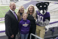 Kalen DeBoer, left, poses for a photo with his wife Nicole, and his daughters Alexis and Avery along with Harry, the Washington mascot, Tuesday, Nov. 30, 2021, at Husky Stadium, following a news conference in Seattle, to introduce DeBoer as the new head NCAA college football coach at the University of Washington. DeBoer has spent the past two seasons as head football coach at Fresno State. (AP Photo/Ted S. Warren)