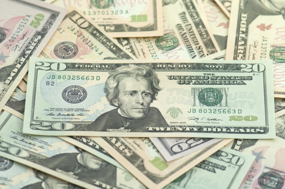 Various U.S. dollar bills, with a twenty-dollar bill featuring Andrew Jackson prominently in the center