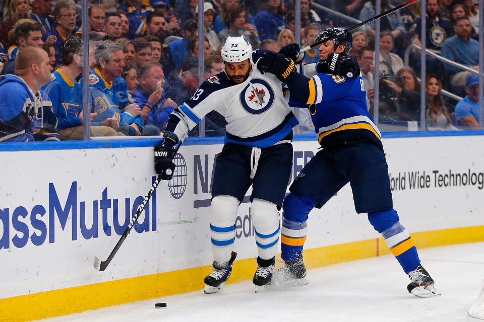 ST. LOUIS, MO - APRIL 20: Jay Bouwmeester #19 of the St. Louis Blues knocks Dustin Byfuglien #33 of the Winnipeg Jets off the puck in Game Six of the Western Conference First Round during the 2019 NHL Stanley Cup Playoffs at the Enterprise Center on April 20, 2019 in St. Louis, Missouri. (Photo by Dilip Vishwanat/Getty Images)