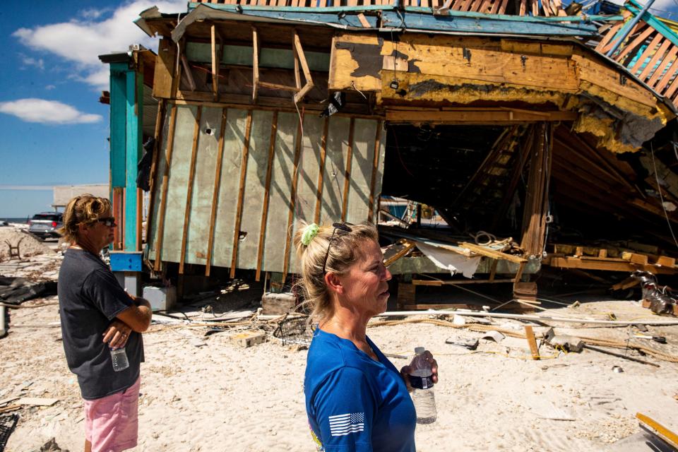 Fort Myers Beach residents and Whale restaurant owners Mike and Dawn Miller survey the destruction Saturday, October 8, 20222 caused by Hurricane Ian. It was the first time they were able to see the damage first hand since the hurricane made landfall. 