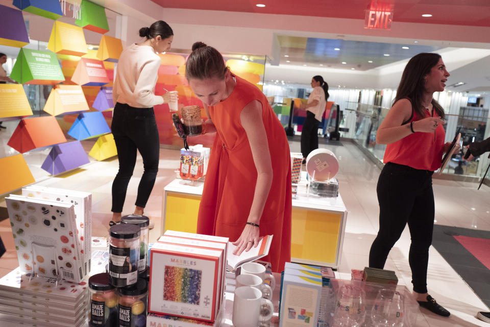 People browse at the opening day of Story, Wednesday, April 10, 2019, at Macy's in New York. Industry watchers are closely watching Macy's partnership with Story. (AP Photo/Mark Lennihan)