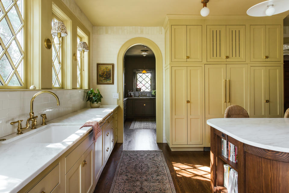 a yellow kitchen with a dark brown back kitchen