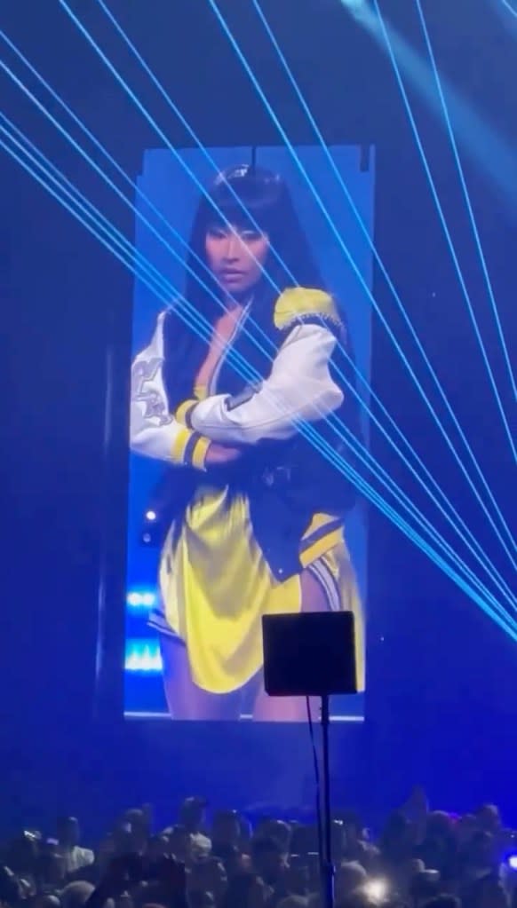 At the beginning of the video, Minaj, 41, can be seen holding onto the yellow material of the dress as she hands the microphone to one of her fans. @theminiajsupreme/Instagram