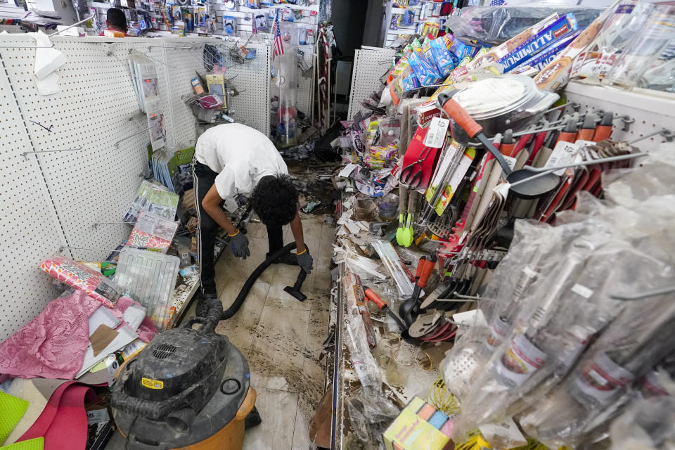 A worker uses a heavy duty vacuum cleaner to collect flood water off the floor of the Dollar Depot store after remnants of Hurricane Ida inundated the community, Saturday, Sept. 4, 2021, in Mamaroneck, N.Y. More than four days after the hurricane blew ashore in Louisiana, Ida's rainy remains hit the Northeast with stunning fury on Wednesday and Thursday, submerging cars, swamping subway stations and basement apartments and drowning scores of people in five states. (AP Photo/Mary Altaffer)