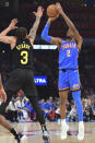 Oklahoma City Thunder guard Shai Gilgeous-Alexander (2) shoots against Utah Jazz guard Keyonte George (3) during the first half of an NBA basketball game Wednesday, March 20, 2024, in Oklahoma City. (AP Photo/Kyle Phillips)