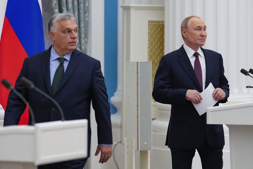 Russian President Vladimir Putin, right, and Hungarian Prime Minister Viktor Orban arrive to make press statements after their talks in the Kremlin in Moscow, Russia, Friday, 