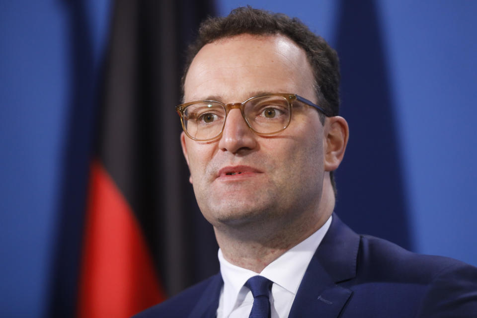 German Health Minister Jens Spahn briefs the media with German Chancellor Angela Merkel after a virtual meeting with federal state governors at the chancellery in Berlin, Germany, Tuesday, March 30, 2021. German health officials agreed Tuesday to restrict the use of AstraZeneca's coronavirus vaccine in people under 60 amid fresh concern over unusual blood clots reported from those who received the shots. (AP Photo/Markus Schreiber, pool)