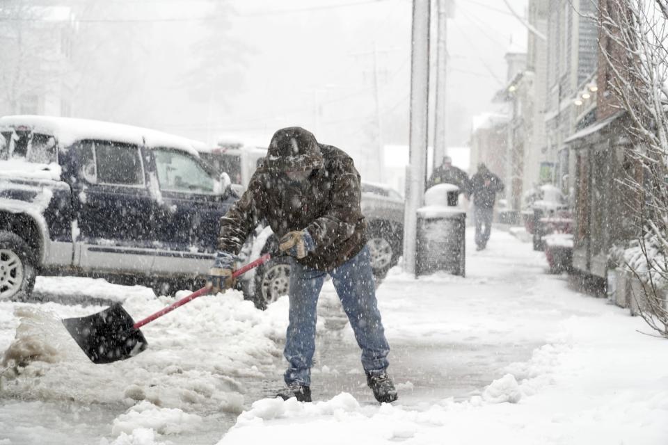 <p>Wayne Cooper shovels slush off of Main Street in West Stockbridge, Mass., to keep water draining, Wednesday, March 2, 2018. (Photo: Ben Garver/The Berkshire Eagle via AP) </p>