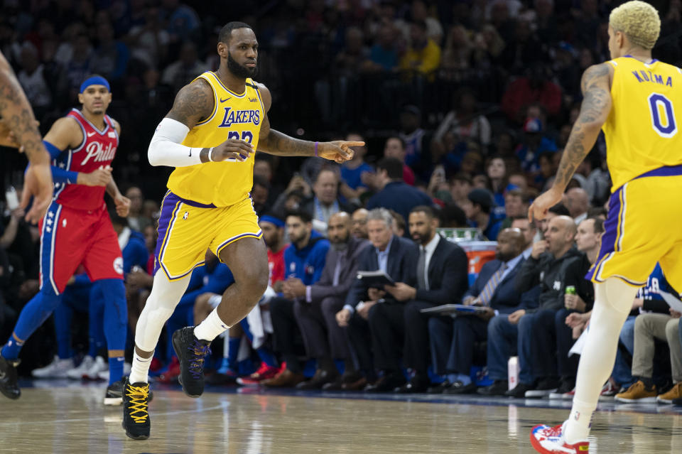 Los Angeles Lakers' LeBron James, center, reacts to his basket moving him to third on the NBA All-time scoring during the second half of an NBA basketball game against the Philadelphia 76ers, Saturday, Jan. 25, 2020, in Philadelphia. LeBron James passes Kobe Bryant for third on the NBA all-time scoring. (AP Photo/Chris Szagola)