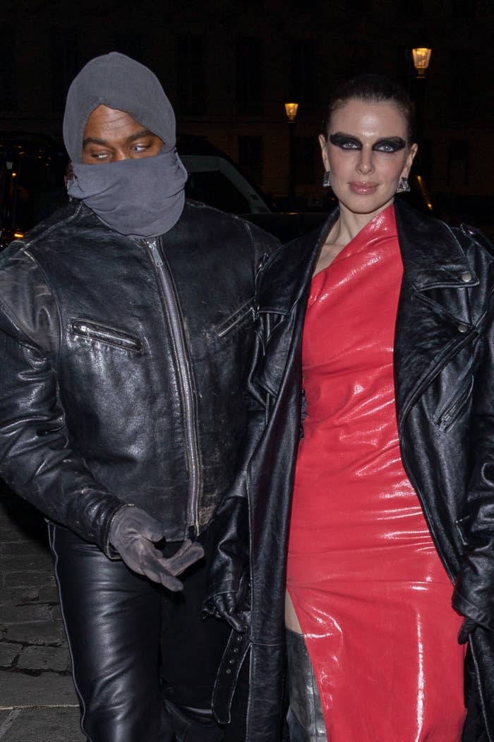 Julia and Kanye walk outside while he wears a face mask