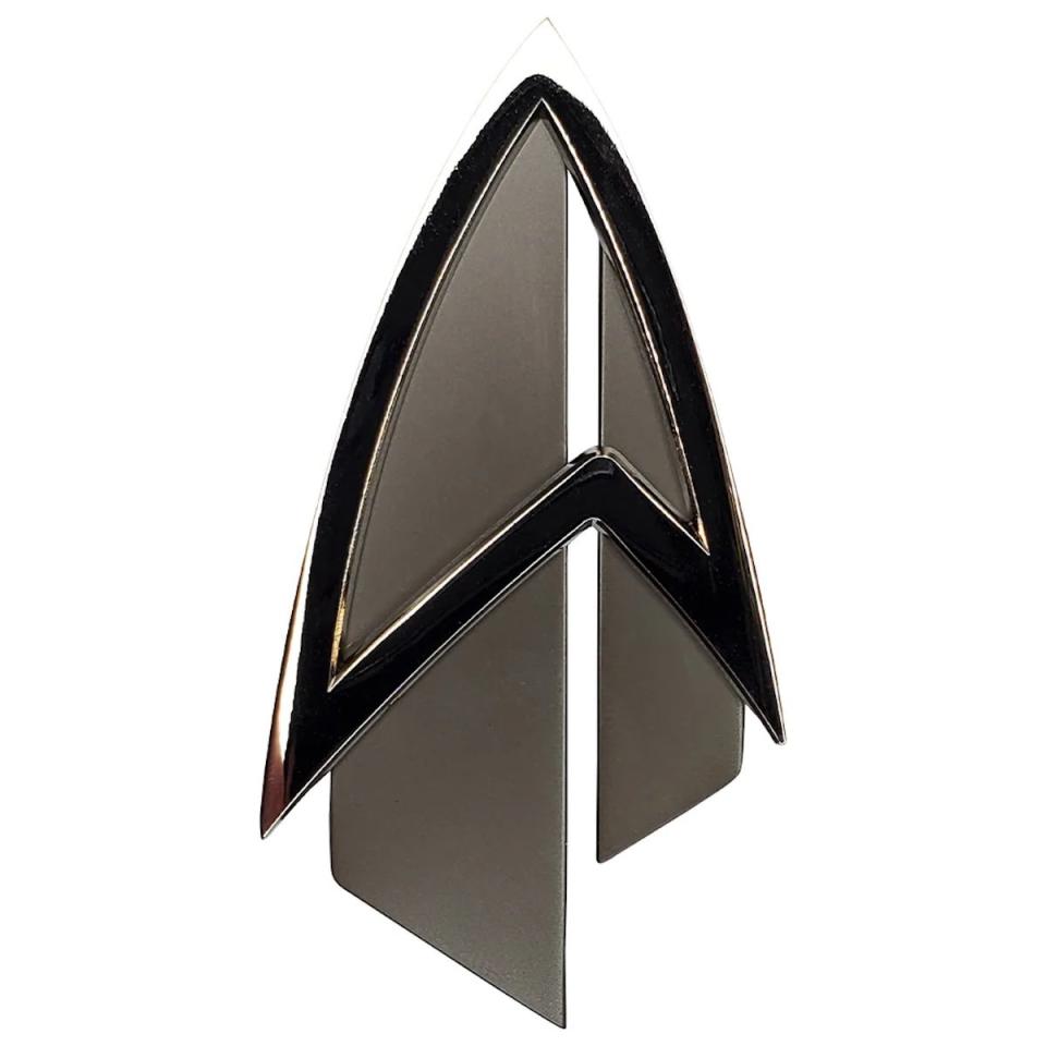 A metal Star Trek replica Delta insignia