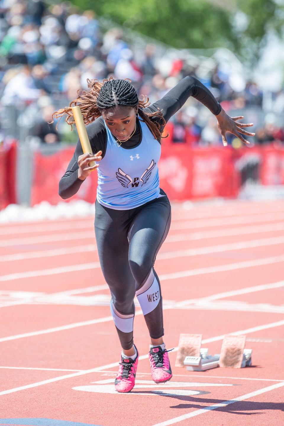 Pueblo West's Nkechi Onyejekwe starts off the Class 4A 4x100 meter relay during the CHSSA state track and field meet in 2022 at Jeffco Stadium.