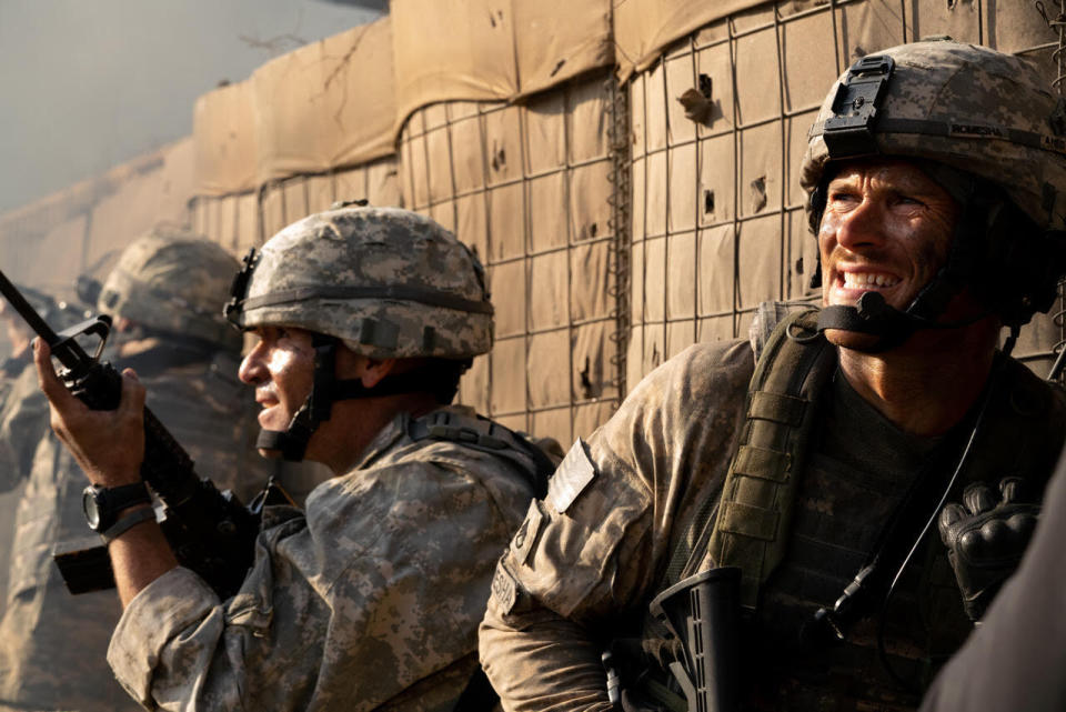 This image released by Screen Media shows Scott Eastwood, right, in a scene from "The Outpost." The film tells the story of the heroic Battle of Kamdesh in Afghanistan in 2009, where the Taliban attacked a remote American Combat Outpost that was nearly impossible to defend. (Screen Media via AP)