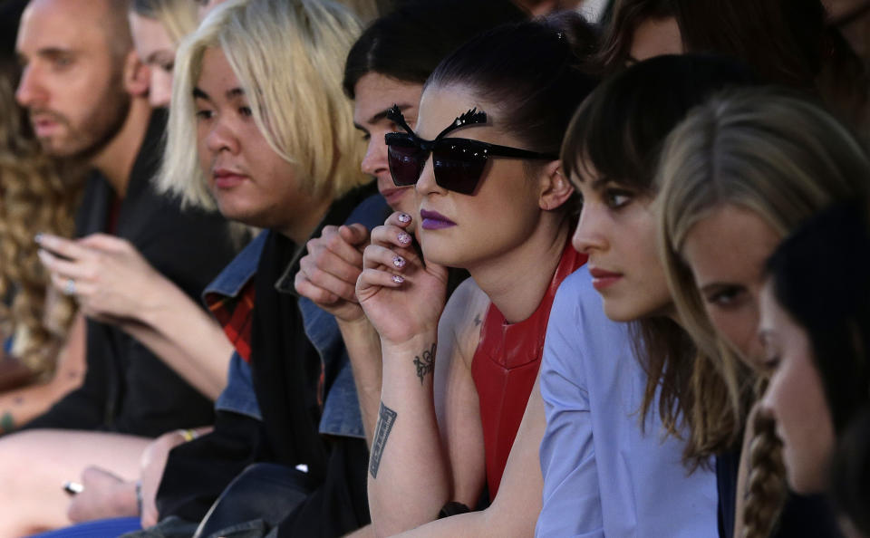 British TV personalitiy Kelly Osbourne, in sun glasses watches the House of Holland Spring/Summer 2013 presentation at London Fashion Week in London, Saturday, Sept. 15, 2012. (AP Photo/Alastair Grant)