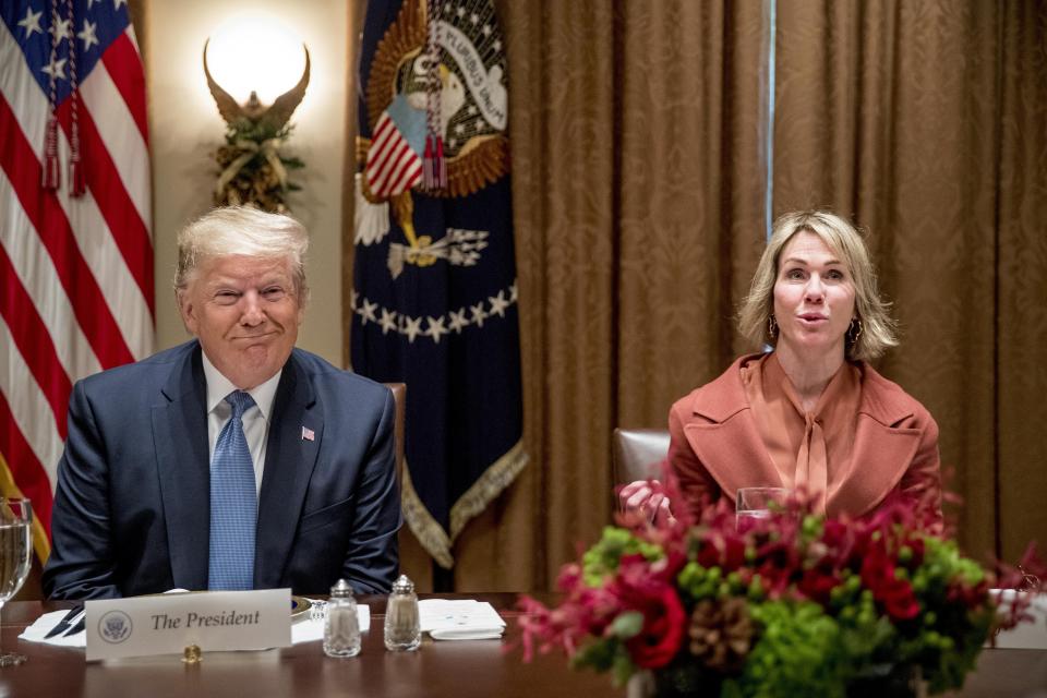 President Donald Trump, left, smiles as U.S. Ambassador to the U.N. Kelly Craft, right, speaks at a luncheon with members of the United Nations Security Council in the Cabinet Room at the White House in Washington, Thursday, Dec. 5, 2019. (AP Photo/Andrew Harnik)