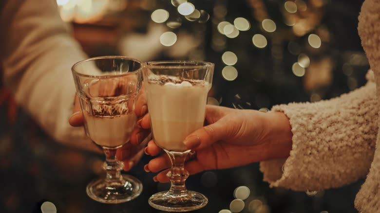 two people holding eggnog