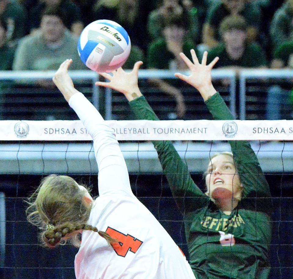Sioux Falls Jefferson's Brooke Thorstenson (4) defends at the net against Sioux Falls Washington's Grace Nesdahl during their Class A semifinal match in the state high school volleyball tournament on Friday, Nov. 18, 2022 in the Denny Sanford PREMIER Center.