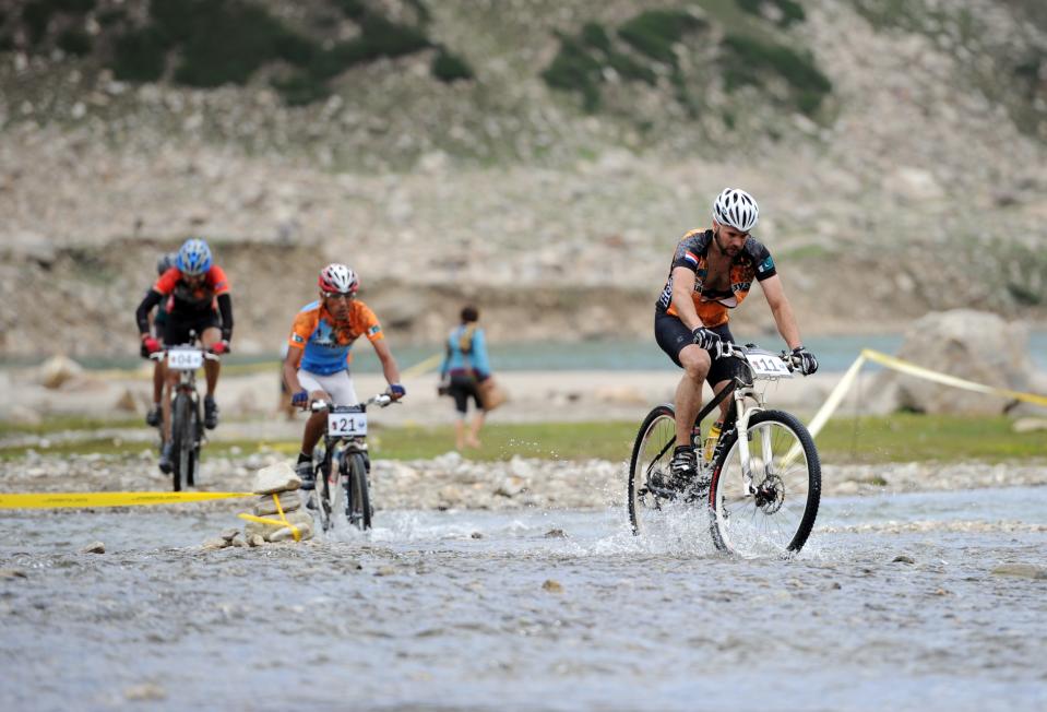 International and local Pakistani cyclists compete during the second stage of the Himalayas 2011 International Mountainbike Race in the mountainous area of Lake Saif-ul-Maluk in Pakistan's tourist region of Naran in Khyber Pakhtunkhwa province on September 17, 2011. The cycling event, organised by the Kaghan Memorial Trust to raise funds for its charity school set up in the Kaghan valley for children affected in the October 2005 earthquake, attracted some 30 International and 11 Pakistani cyclists. AFP PHOTO / AAMIR QURESHI (Photo credit should read AAMIR QURESHI/AFP/Getty Images)