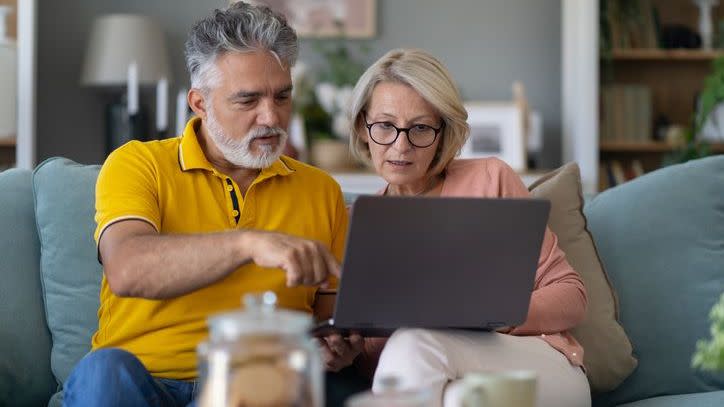 A retired couple adjusts their retirement savings portfolio, shifting some of their money into more conservative assets. 