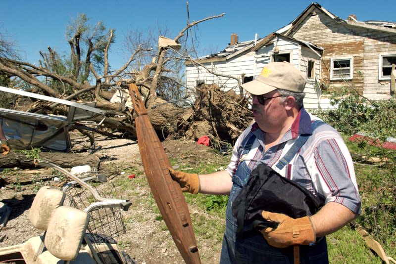 Darrell Roderick of Kansas City, Mo., helped salvage items from his mother-in-law's property May 5, 2003, after a tornado tore through the area the night before. File Photo by Todd Feeback/UPI