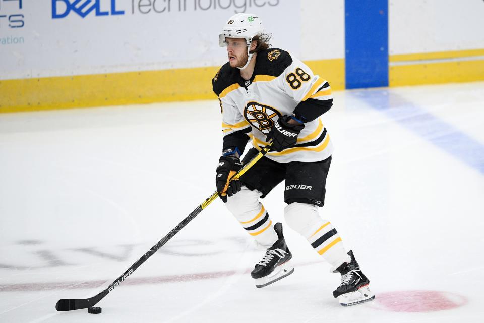 Boston Bruins right wing David Pastrnak (88) skates with the puck during the second period of an NHL hockey game against the Washington Capitals, Saturday, Jan. 30, 2021, in Washington. (AP Photo/Nick Wass)