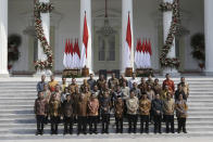 Indonesian President Joko Widodo, front row sixth from left, and his deputy Ma'ruf Amin, seventh from left, pose for photographers during the announcement of the new cabinet at Merdeka Palace in Jakarta, Indonesia, Wednesday, Oct. 23, 2019. (AP Photo/Dita Alangkara)