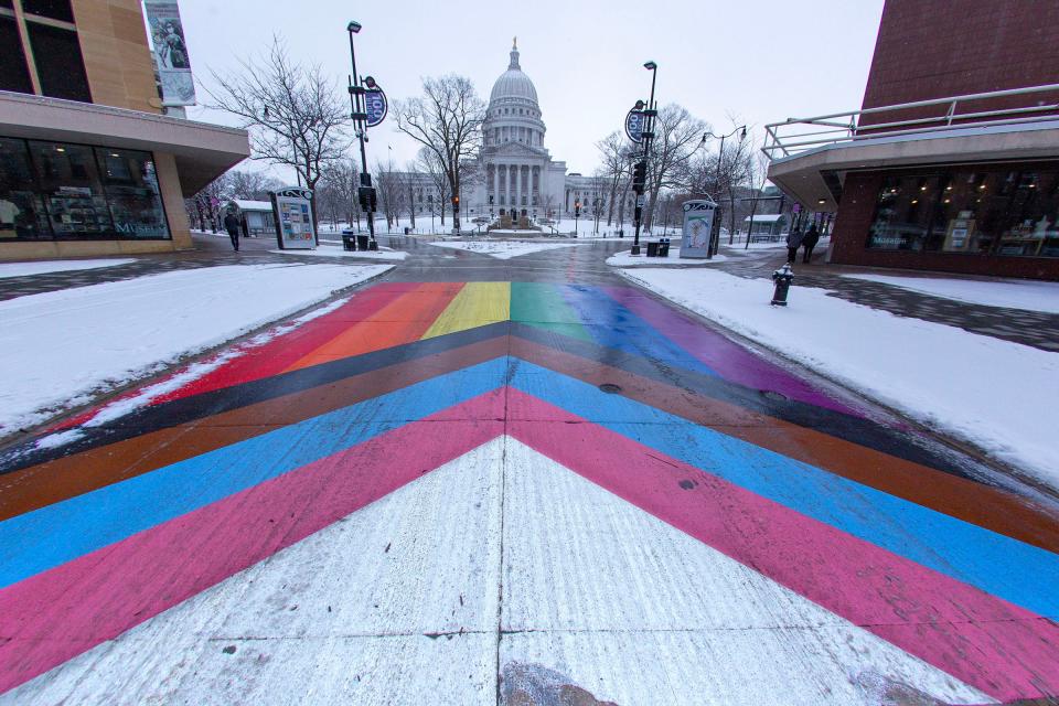 The LGBTQ (Lesbian, gay, bisexual, transgender and queer) flag is painted on State Street outside the Capitol in Madison on Sunday, Jan. 22, 2023. Dane County, including Madison, is looking to become the first county in the state to declare itself a "sanctuary" for transgender and nonbinary people.