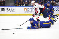 Buffalo Sabres defenseman Connor Clifton (75) dives for the puck in front of Washington Capitals center Aliaksei Protas (21) during the second period of an NHL hockey game Thursday, April 11, 2024, in Buffalo, N.Y. (AP Photo/Jeffrey T. Barnes)