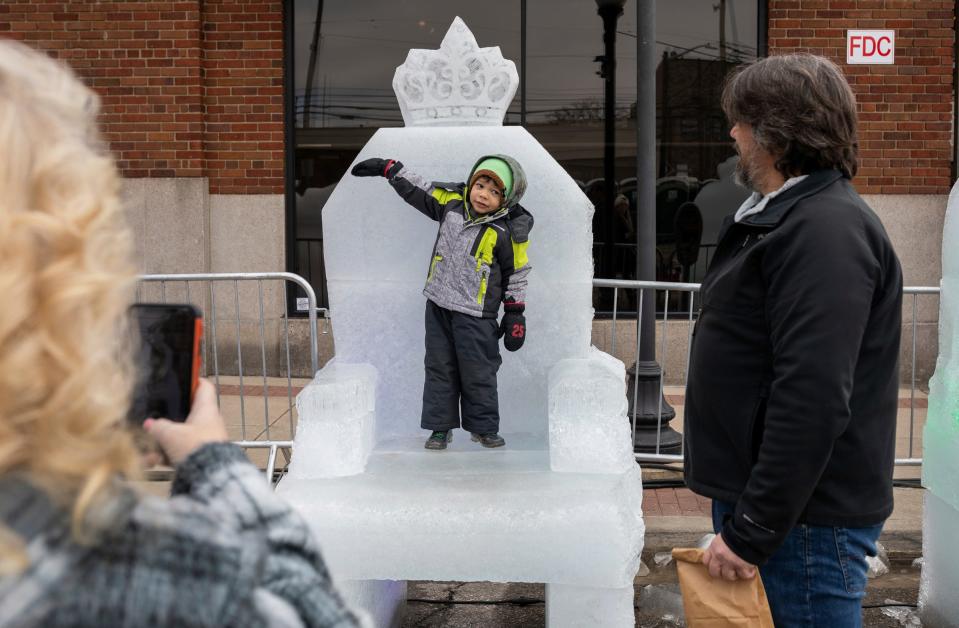 CJ Robinson stands on an ice throne as his grandma and grandpa watch him during the Winter Blast Royal Oak on Saturday, Feb. 3, 2024. The weekend-long event features outdoor activities and vendors, including food trucks, ice sculptures, live music, an ice garden, ice skating, e-sports, food, and more.