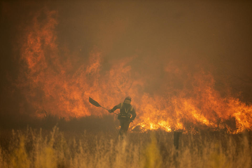 A firefighter works in front of flames during a wildfire in the Sierra de la Culebra in the Zamora Provence on Saturday June 18, 2022. Spain is breathing a sigh of relief as a sharp drop in temperatures is helping firefighters contain wildfires across the country that destroyed tens of thousands of acres of wooded land. But it’s still only June. Extended drought conditions in several Mediterranean countries, a heat wave last week that reached northern Germany and high fuel costs needed to operate firefighting aircraft have already heightened concerns across Europe this summer. (Emilio Fraile/Europa Press via AP)