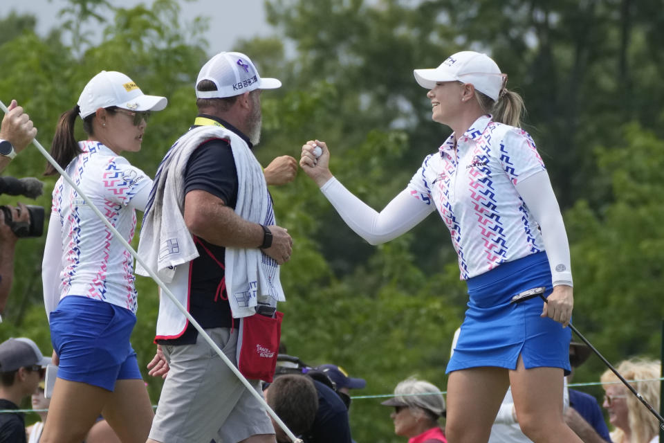 Matilda Castren of Finland, right, fist bumps her playing partner Kelly Tan on the 11th green during the final round of the Dow Great Lakes Bay Invitational golf tournament at Midland Country Club, Saturday, July 22, 2023, in Midland, Mich. (AP Photo/Carlos Osorio)