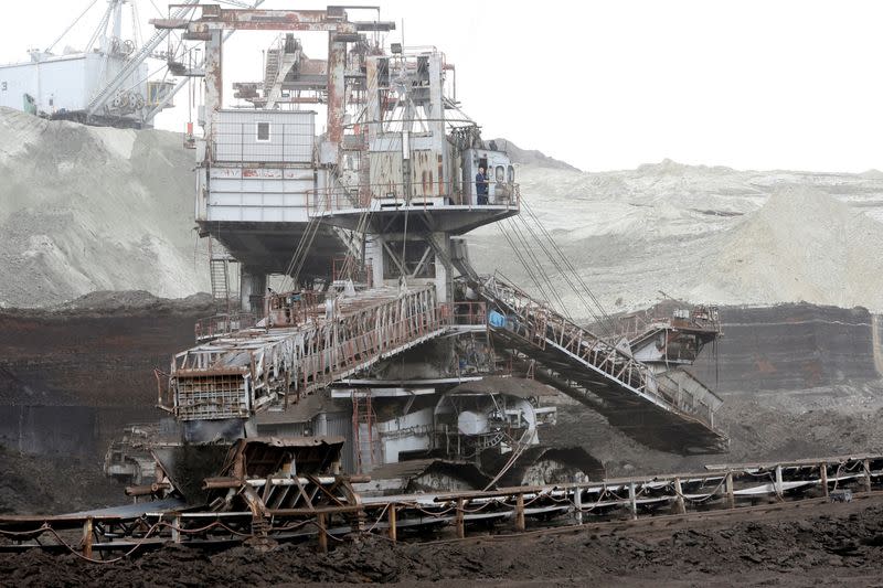 FILE PHOTO: Excavators dig coal near the largest domestic electricity production facility REK Bitola in Bitola