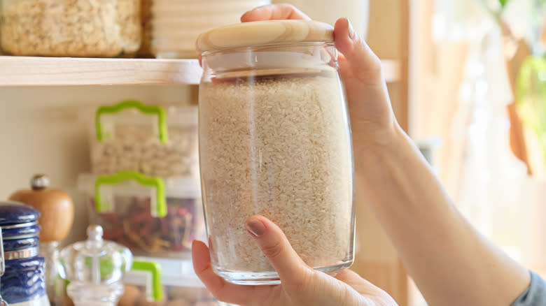 Person holding jar of rice