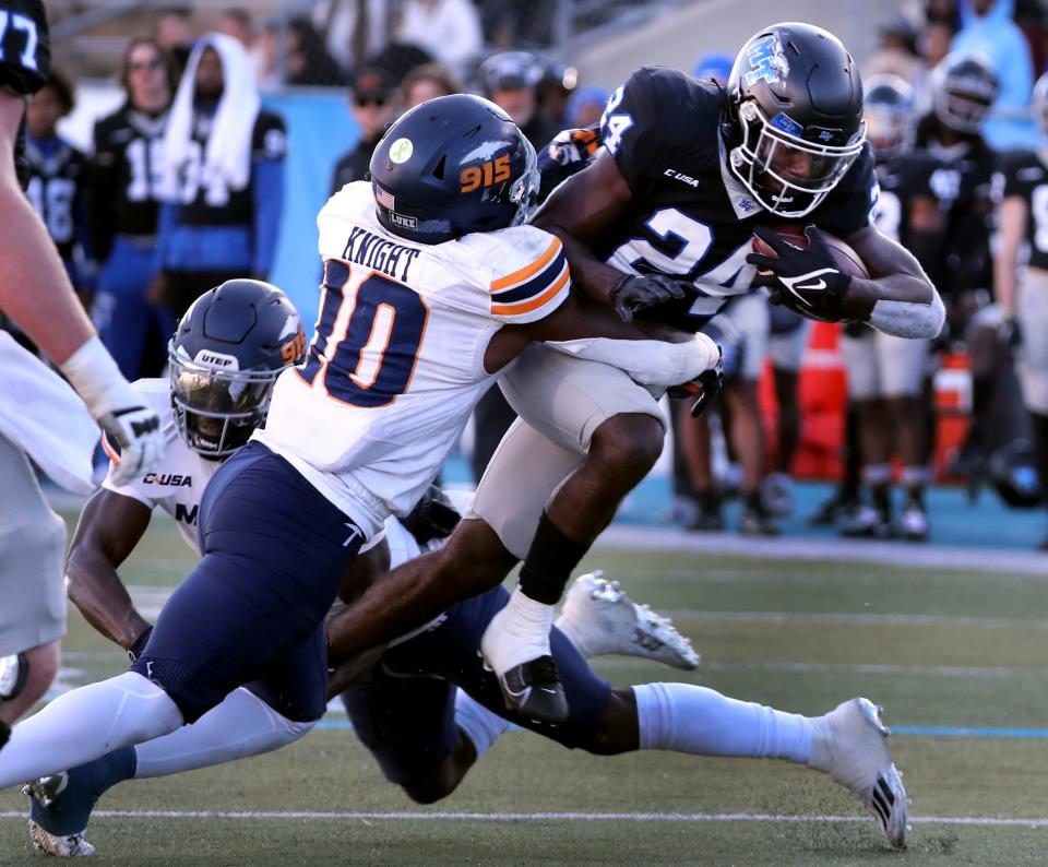 Middle Tennessee running back Frank Peasant (24) runs the ball as UTEP linebacker Tyrice Knight (10) tackles him during the football game in Johnny “Red” Floyd Stadium at MTSU in Murfreesboro, Tenn. on Saturday, Nov 18, 2023.