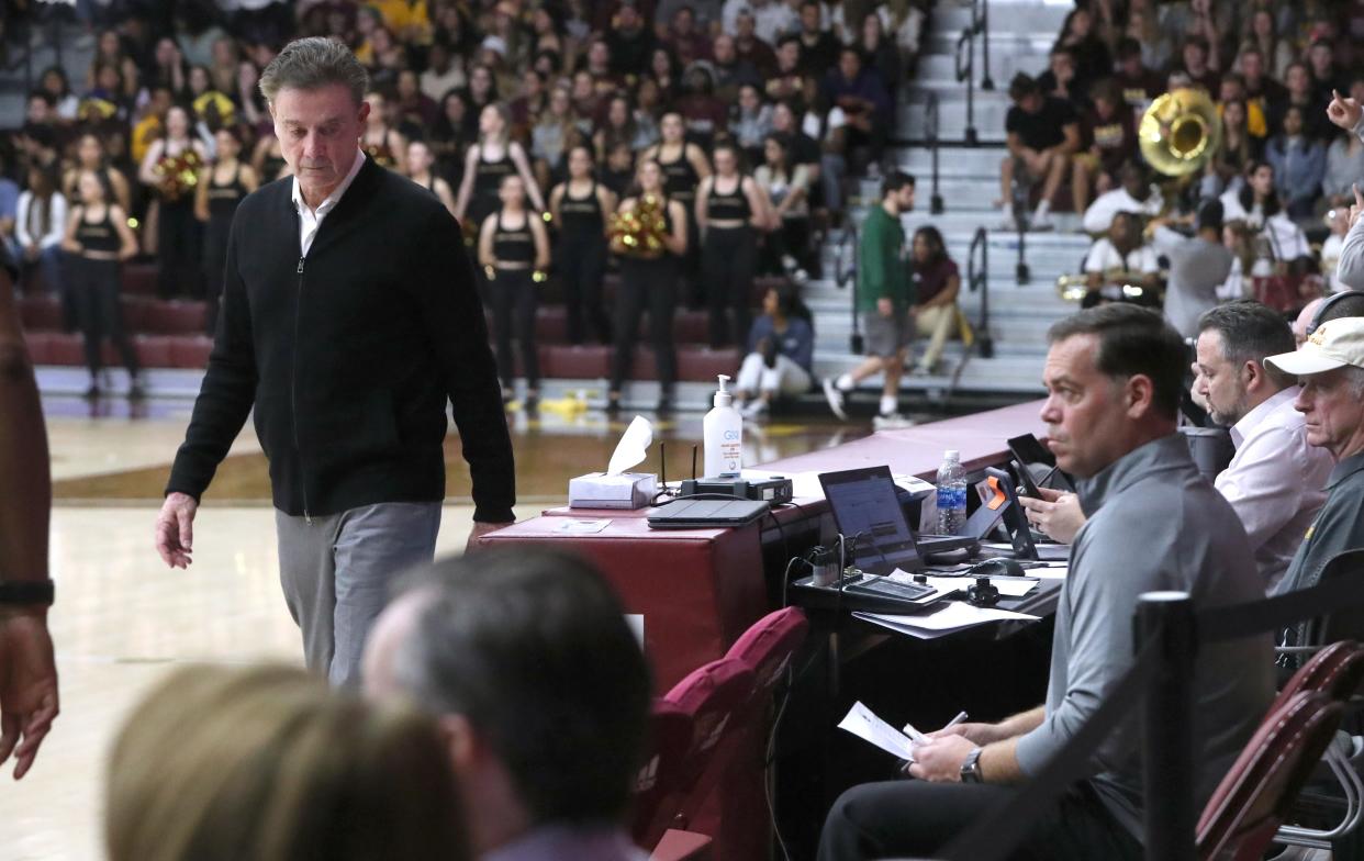 Iona head coach Rick Pitino walks by former Manhattan College coach Steve Masiello, far right, who was seated behind the Iona bench during a game at Iona Nov. 7, 2022. Iona beat Penn 78-50.