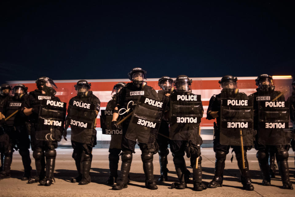 Police officers hold their line.