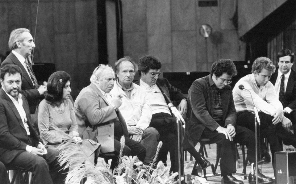 FILE - In this Dec. 19, 1982, file photo Conductor Zubin Mehta, left, with seven of the world greatest violinists Ida Haendal (2nd left), Isaac Stern, Ivry Gitlis, Pinchas Zukerman, Itzhak Perlman and Shlomo Mintz and Dr. Steven Paul, right, during a press conference held in Tel Aviv, Israel. Ivry Gitlis, an acclaimed violinist who played with famed conductors, rock stars and jazz bands around the world and worked to make classical music accessible to the masses, has died in Paris at 98. (AP Photo/Max Nash)