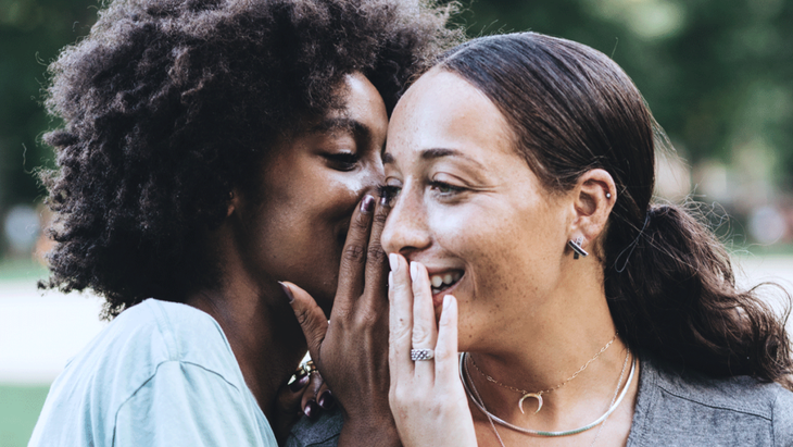 Two women whispering