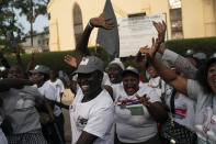 Supporters of the Gambian President Adama Barrow celebrate the partial results that give the lead to their candidate during the counting ballots in Gambia's presidential election, in Banjul, Gambia, Sunday, Dec. 5, 2021. Election officials in the West African nation of Gambia have started counting marble votes after polls closed for the first presidential election in decades that does not include former dictator Yahya Jammeh as a candidate. (AP Photo/Leo Correa)