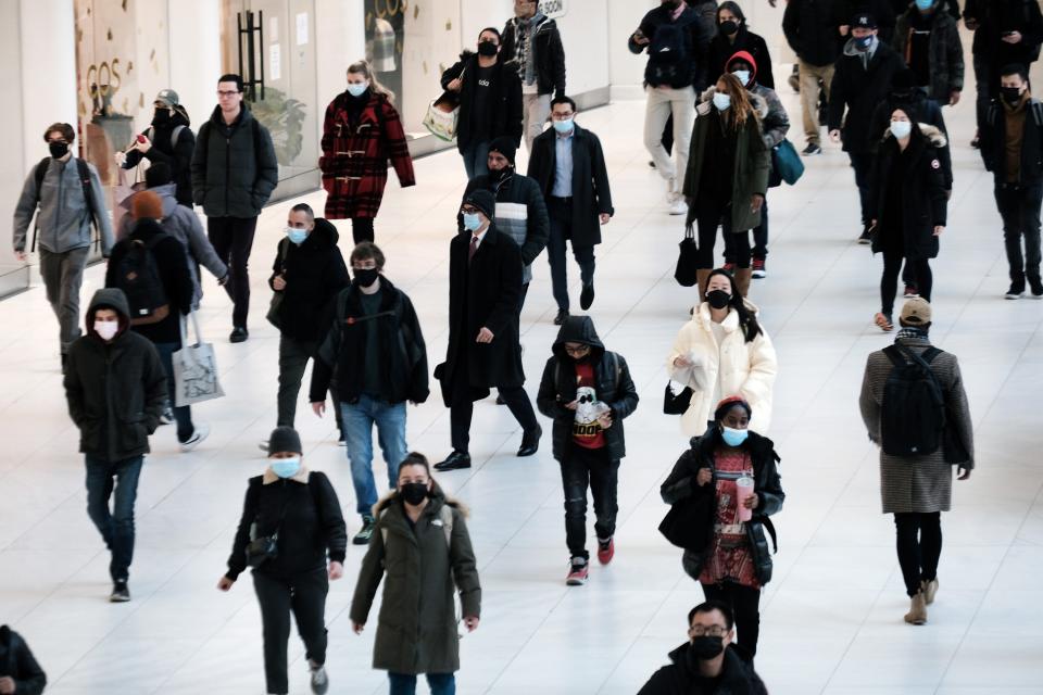 People wear masks at an indoor mall in The Oculus in lower Manhattan on Monday, when a mask mandate went into effect in New York state amid a surge of COVID-19 cases.