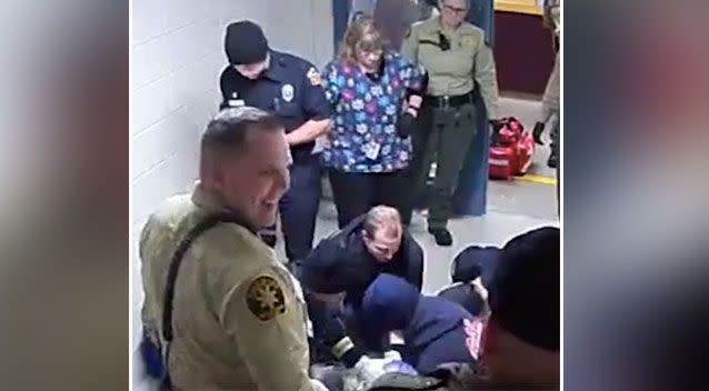 The officer turns round and laughs with other staff members. Source: San Luis Obispo Sheriffs Office